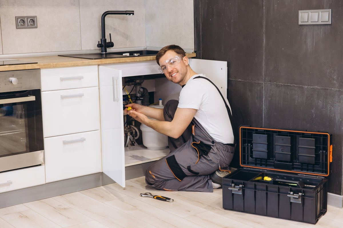 Professional plumber installing water filter system